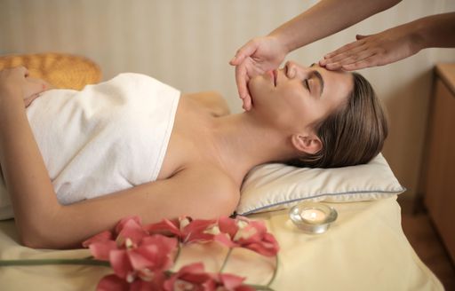 An attractive young female getting a massage in a spa salon - health and healing concept