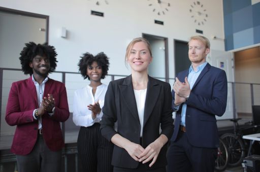 A successful female team leader in a formal outfit presenting the new business project to her multiethnic partners in a modern startup office
