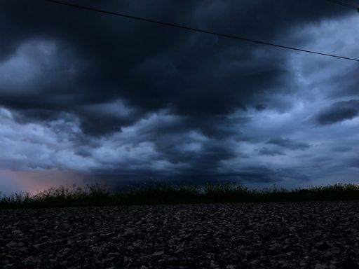 The gloomy landscape with the dark cloudy sky.