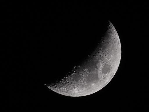 A macro shot of the moon on a black night sky