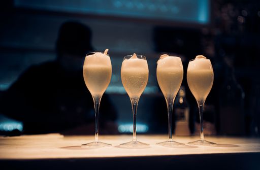 A beautiful shot of the glasses full of champagne on a bar table