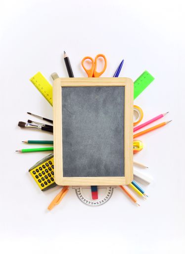 A closeup of school supplies on white background