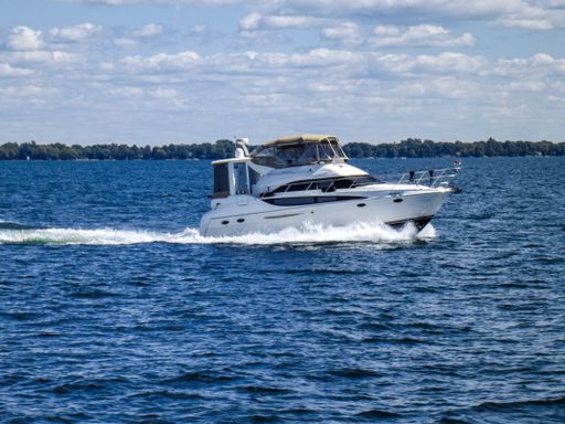 A meridian motor yacht cruising through the waves on Georgian Bay Ontario, Canada