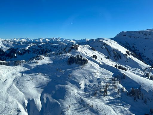 A chilling view of a winter mountain landscape under a blue sky