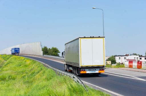 Transport truck with trailer on a asphalt road.