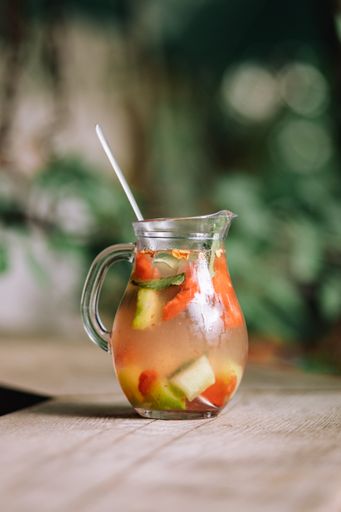A vertical shot of a lemonade made from watermelons on the wooden table