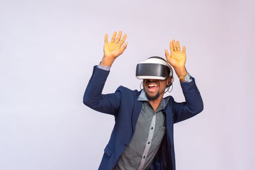 An African businessman wearing a virtual reality glasses isolated on a white background
