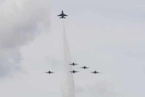 A view of a herd of General Dynamics F-16 Fighting Falcon planes flying high in the gray sky