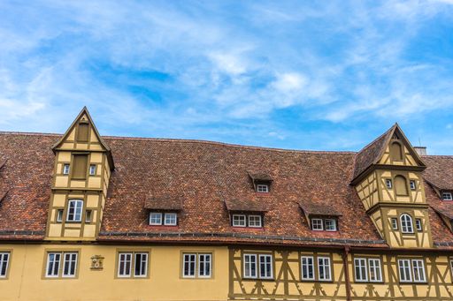 A low angle shot of a historic yellow building in Rothenburg ob der Tauber, Germany