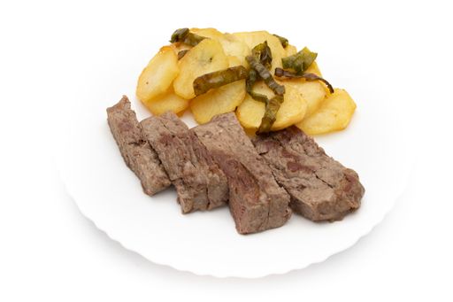 A closeup shot of French fries with roast beef cut into strips isolated on a white background