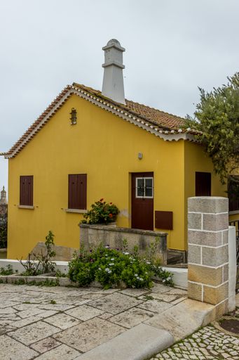 A vertical shot of a picturesque yellow house in Albufeira city, Portugal