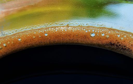 A closeup shot of coffee foam in the cup