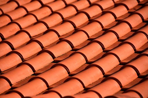 A high angle closeup shot of the red tiles of the roof