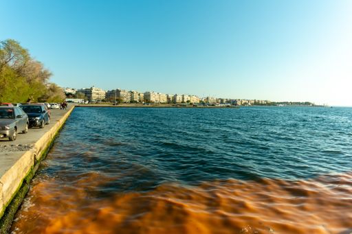 A wide angle shot of the peaceful water under the blue sky