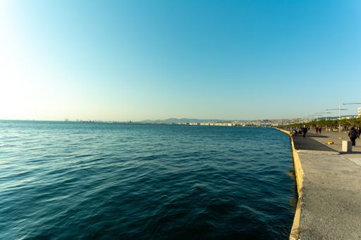 A wide angle shot of the peaceful water under the blue sky