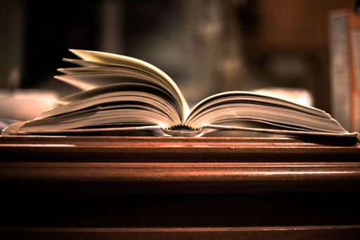 A closeup of an Open book pages on bokeh blurred background