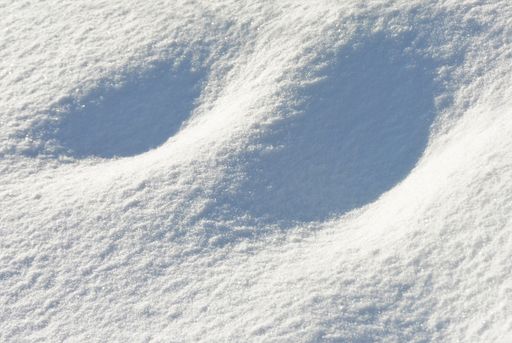 A closeup shot of beautiful dunes of snow during daytime
