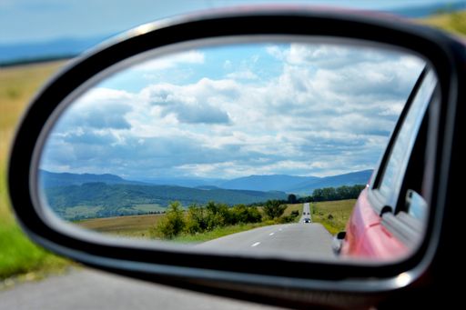 A beautiful picture of the landscape seen through the rearview mirror