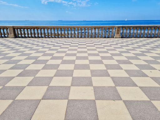 A terrace overlooking the sea with blue sky on the background     in Livorno, Tuscany, Italy