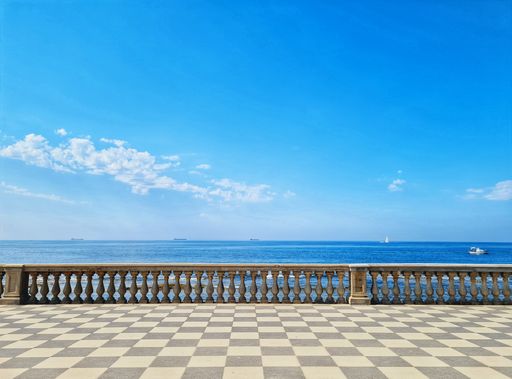 A terrace overlooking the sea with blue sky and white clouds on the background in Livorno, Italy