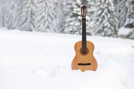 A closeup of a guitar in a snow