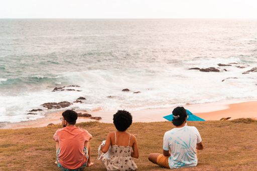 A closeup of a group of people sitting on the beach