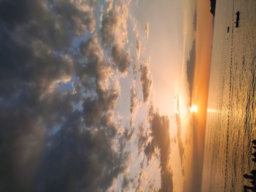 A vertical shot of a beautiful sunset sky over a sea
