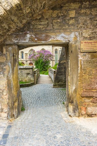 A vertical shot of an entrance of Saint Wolfgangskirche gothic fortress church in Rothenburg ob der Tauber, Germany