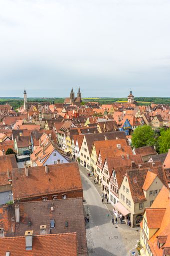 A vertical shot of the houses with orange roof tiles in Rothenburg ob der Tauber, Germany