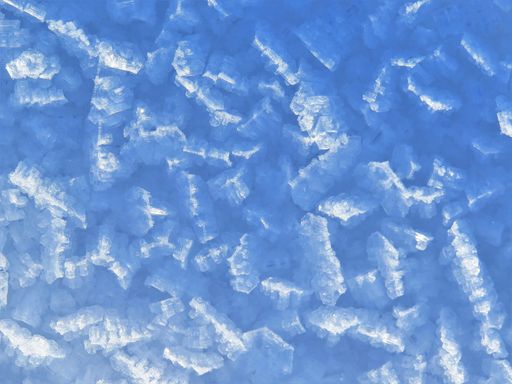 A top view shot of small crystals of ice in the snow layer surface