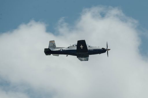 A closeup shot of an aircraft flying overhead during a training exercise