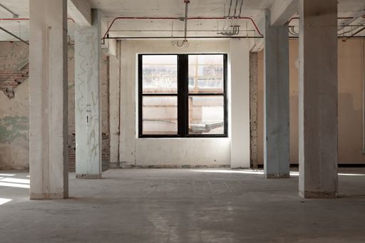 A beautiful shot of windows and the pillars from an abandoned building