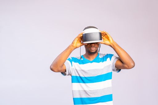 A closeup of a young man wearing a virtual reality headset