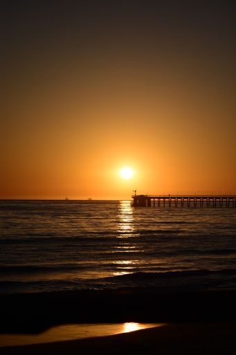 A pier over the Pacific Ocean during a breathtaking sunset in Goleta, California