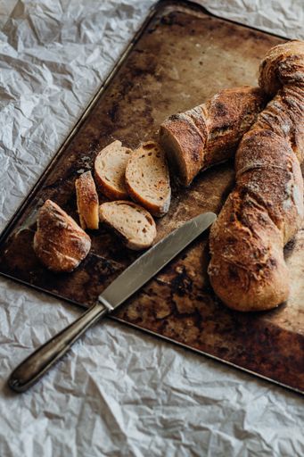A vertical shot of slices of baguette bread on a chopping board
