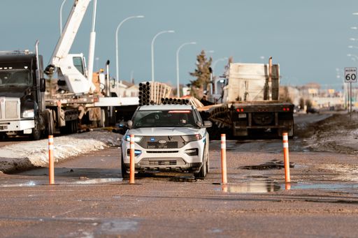 An Airdrie police car blocking the traffic at a semi-truck rollover
