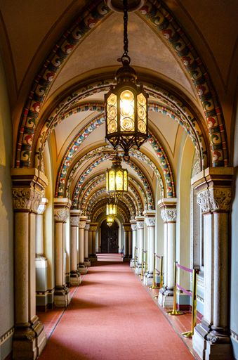 A vertical shot of the hallway with pointed arches inside the New Swan Castle, Germany