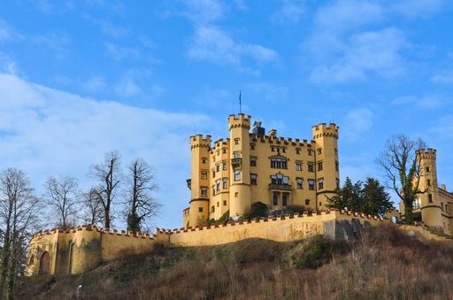 The yellow historic Hohenschwangau Castle under the German Alps, Schwangau