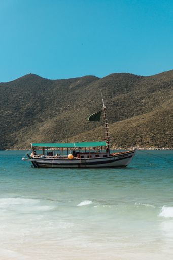 A vertical shot of a boat sailing at Arraial do Cabo, Rio de Janeiro, Brazil