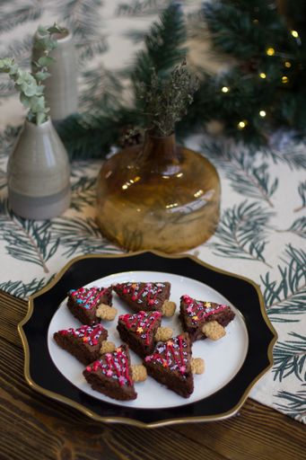 A vertical selective closeup shot of baked chocolate biscuits in a triangular shape on a plate