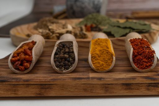 wooden spoons with different types of spices and blurring