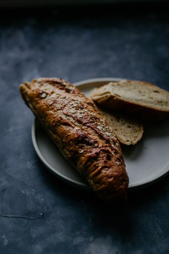 A vertical selective closeup shot of a baked bread on a plate