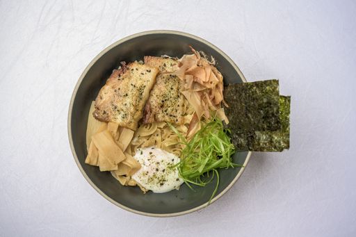 A high angle shot of Asian meal with salmon and seasonings