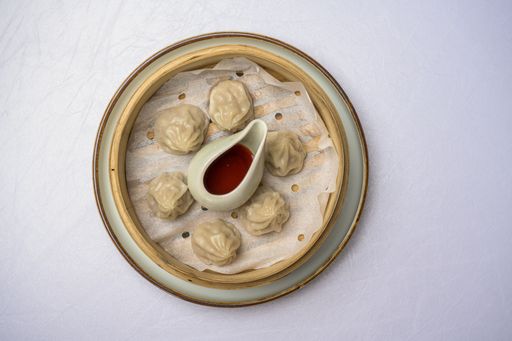 The tasty dumplings with a sauce in the plate