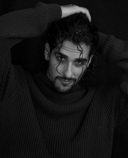 A Hispanic handsome man posing for the camera