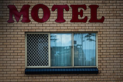 The beautiful shot of a Motel building with a red motel sign