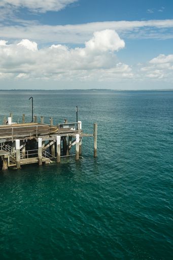 A vertical view of the shore bridge built in the ocean on a sunny day in Australia