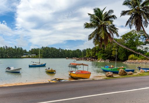 A view of boats moored in a small bay in the tropical village on Praslin island in Seychelles