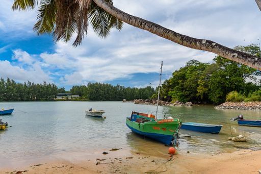 A view of boats moored in a small bay in the tropical village on Praslin island on Seychelles