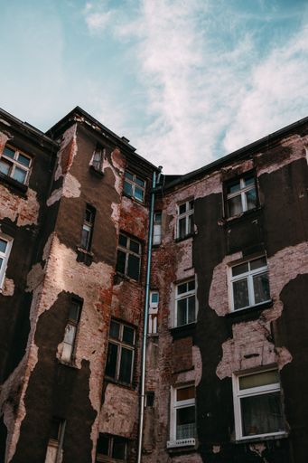 A vertical shot of an old building with a weathered facade
